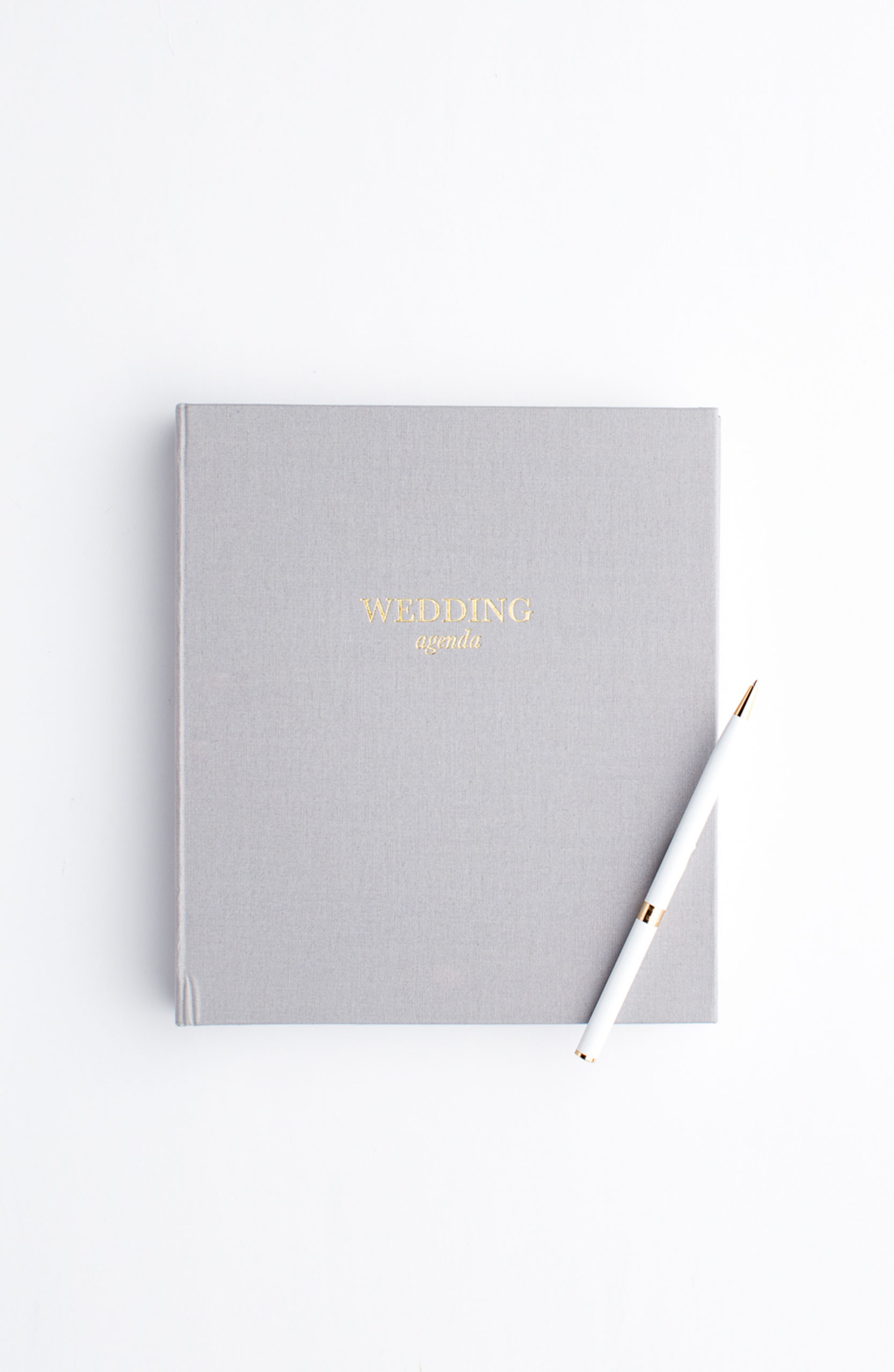 photo of a wedding planner book and pen