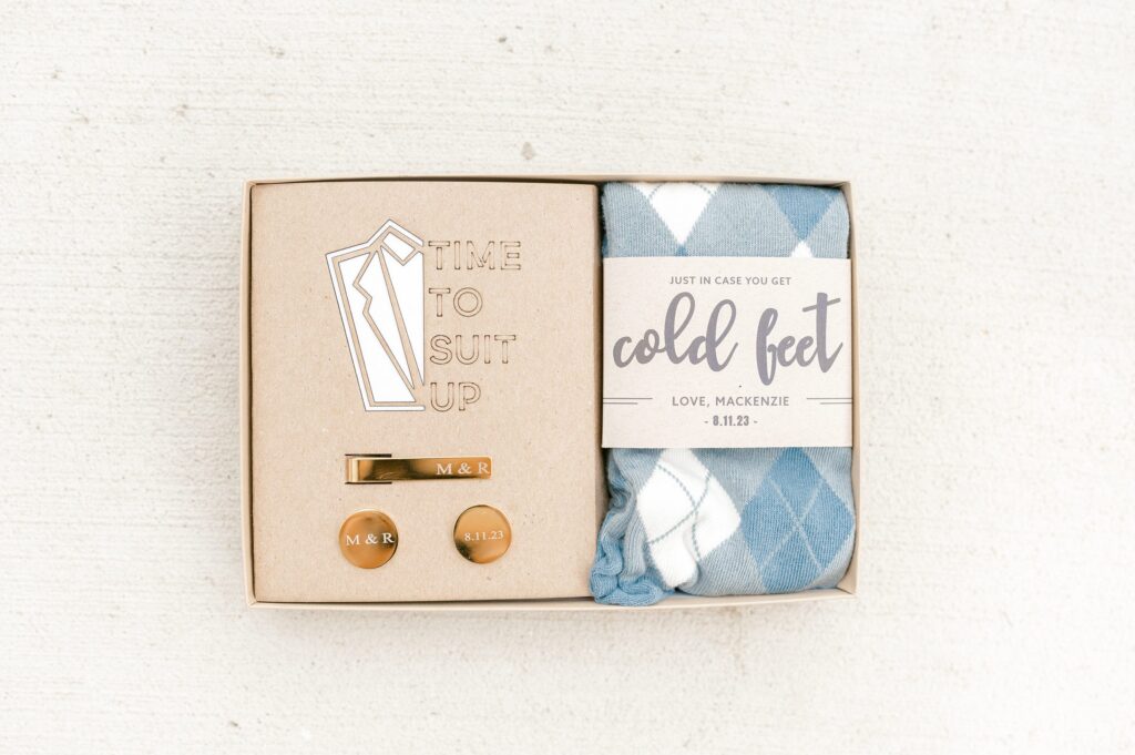 Wedding details including rings, flowers, and invitations at Mackenzie & Russell’s Shelbyville Michigan Bay Pointe Inn wedding