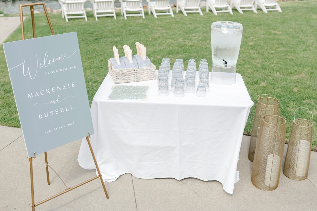 Ceremony at Bay Pointe Inn Pavilion during Mackenzie & Russell’s Shelbyville Michigan wedding with sunset over Gun Lake