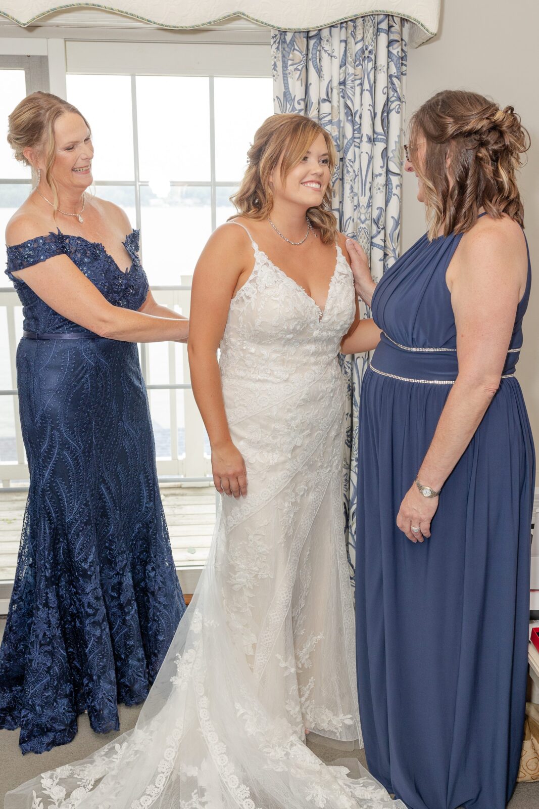 Wedding details including rings, flowers, and invitations at Mackenzie & Russell’s Shelbyville Michigan Bay Pointe Inn wedding