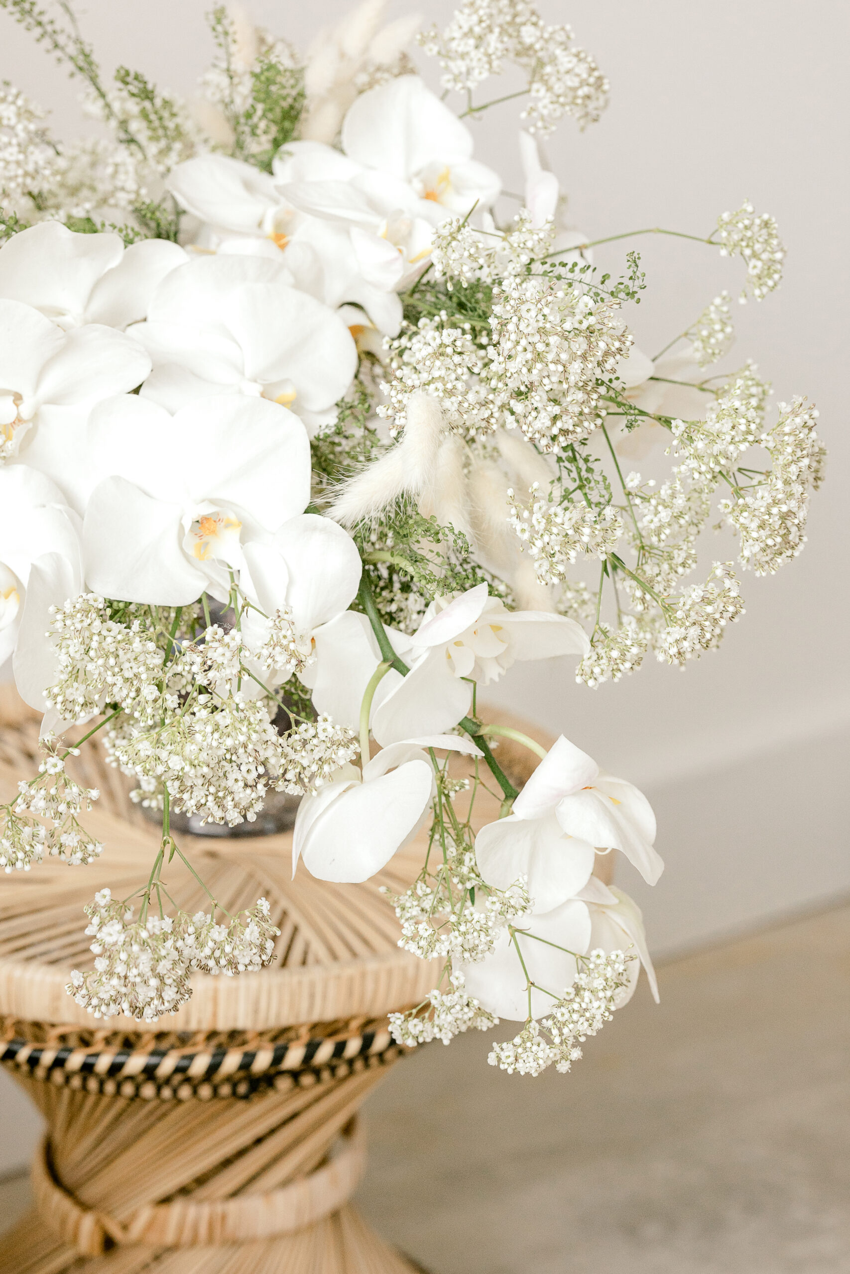 Elegant white orchid and baby's breath wedding floral arrangement captured by Michigan wedding photographer Kara Hanes