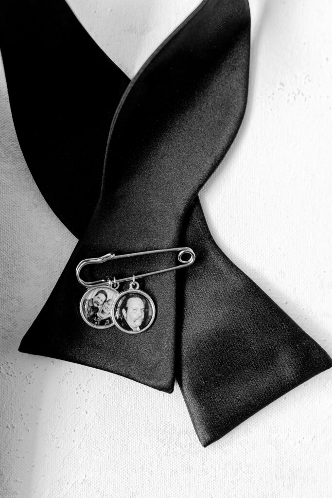 Black bow tie with a photo charm pin