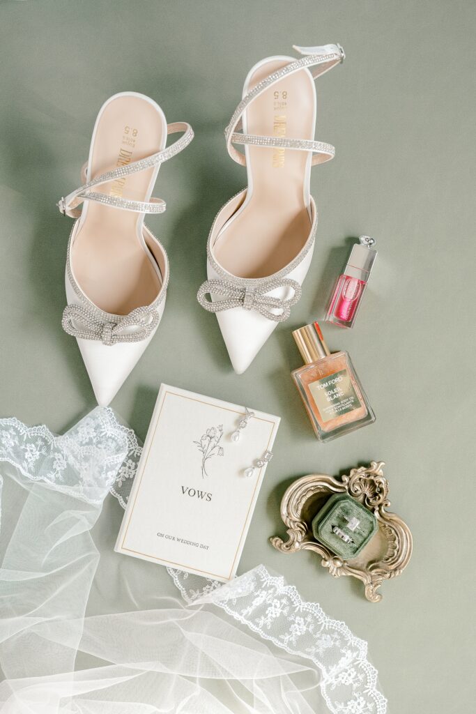 Bridal heels, perfume and stationery styled for wedding day details