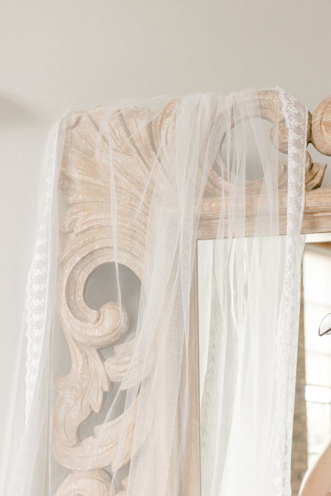 Bridal veil draped over a carved wooden mirror frame
