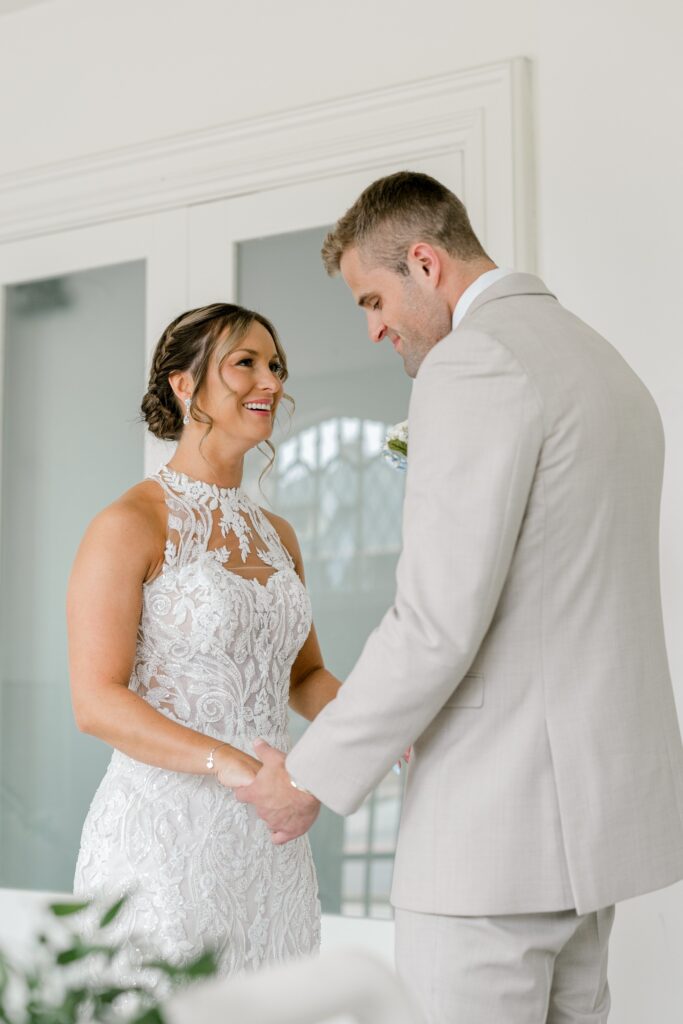 Bride and groom reading private vows to each other before the ceremony