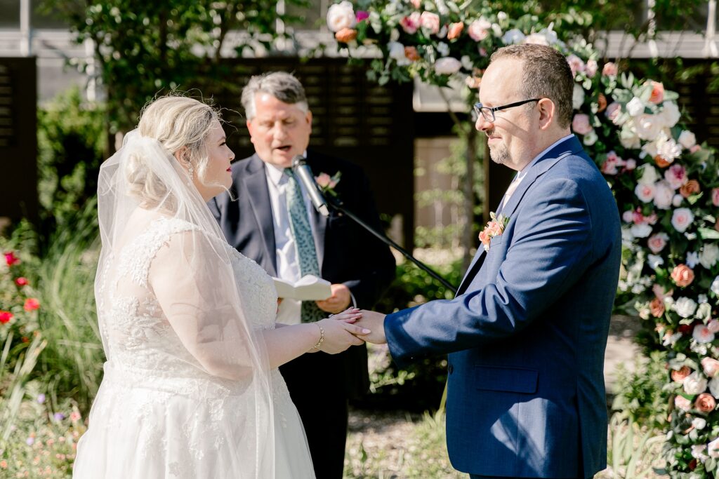 Bride and groom exchanging vows in the garden