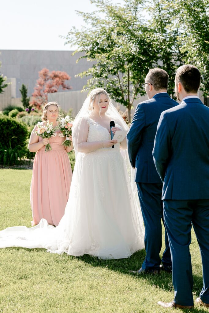 Bride and groom holding hands at the altar with their maid of honor and best man