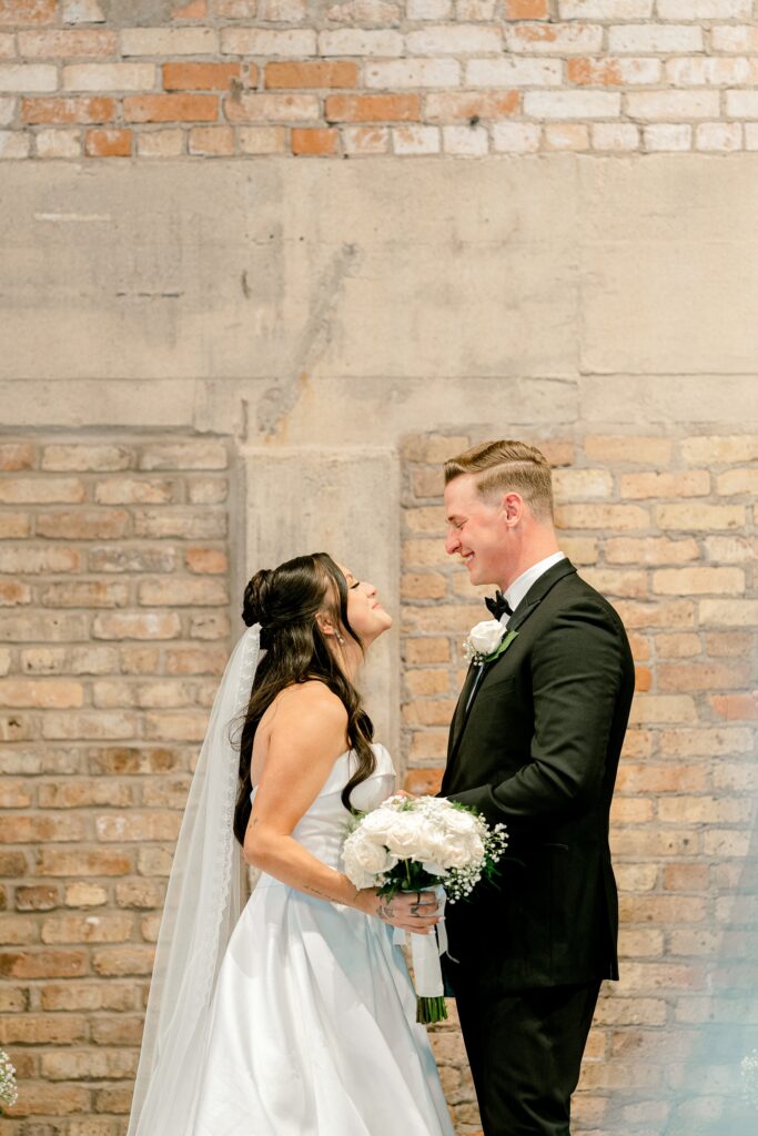 Bride and groom laughing together during the ceremony