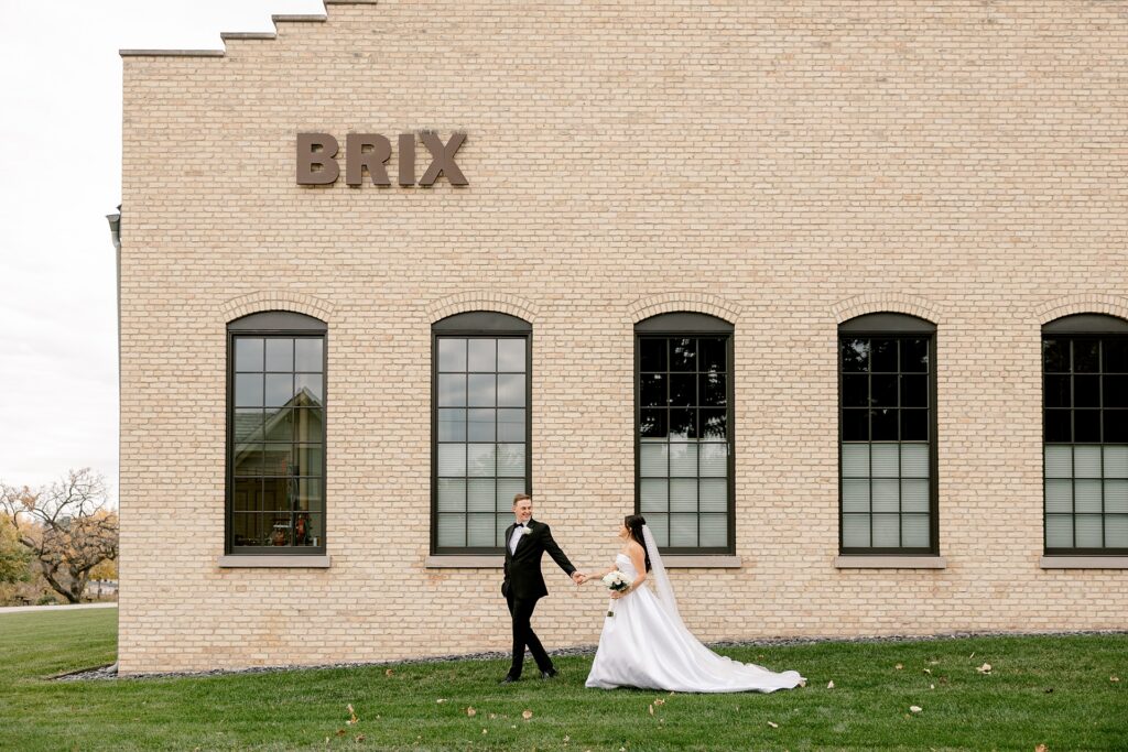 Bride and groom walking past The BRIX building sign