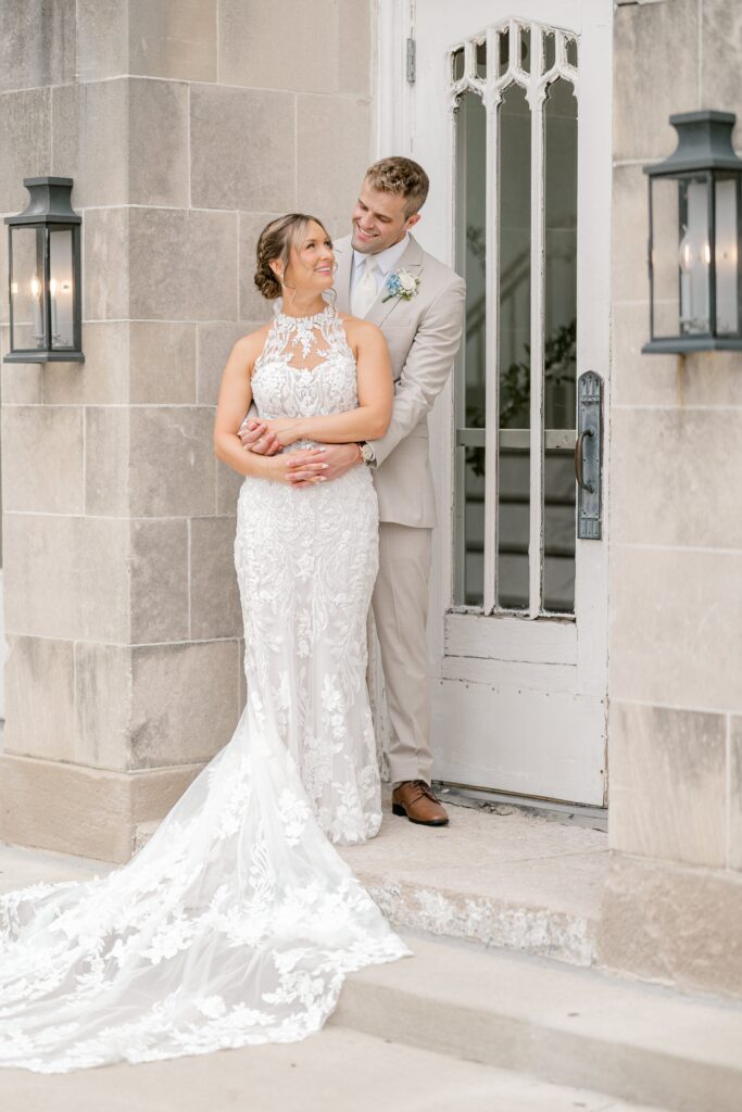 Bride posing in front of the arched windows of The Broadway Avenue