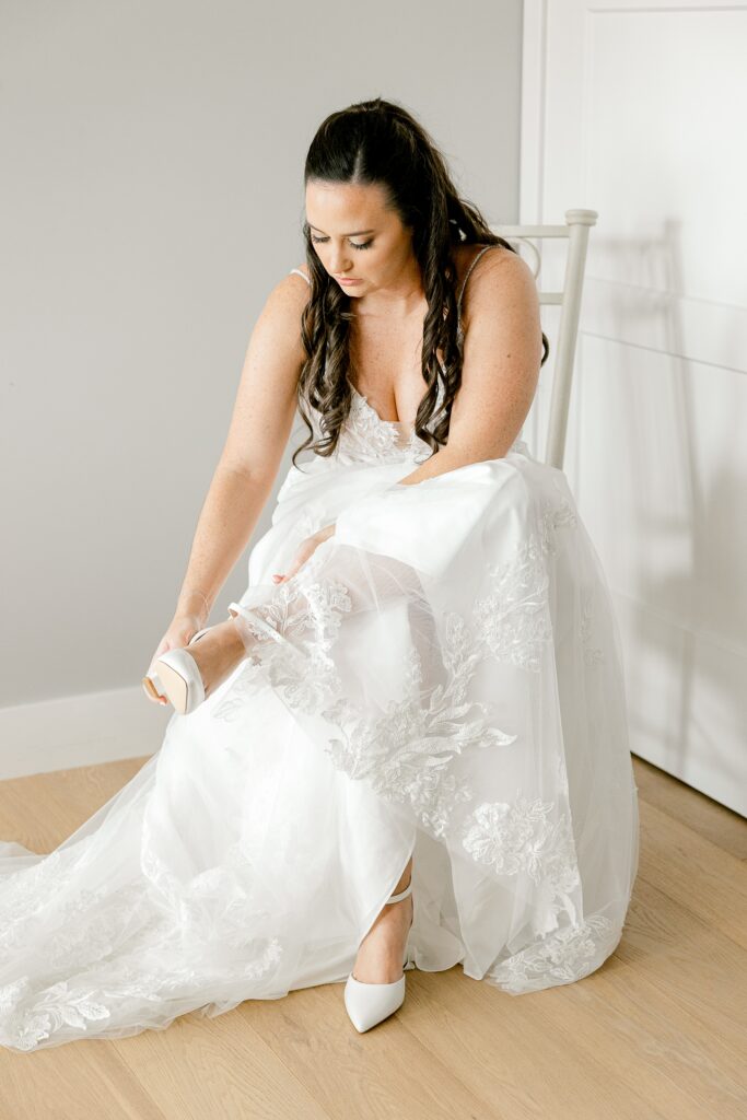 Bride putting on her shoes while getting ready