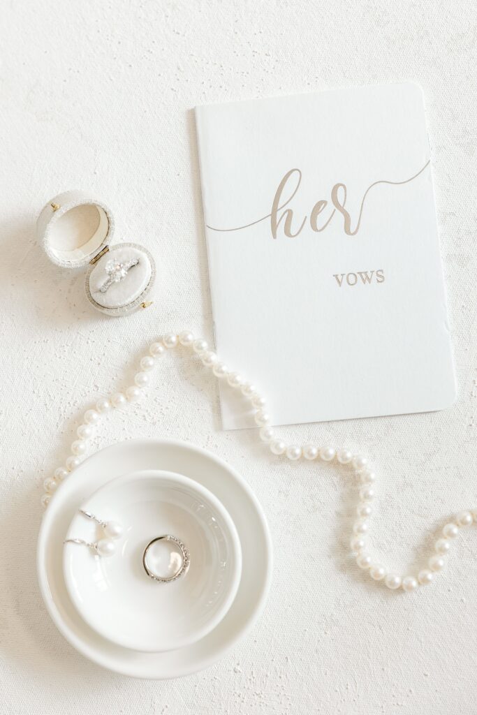 Bride's vow book with pearls and wedding rings