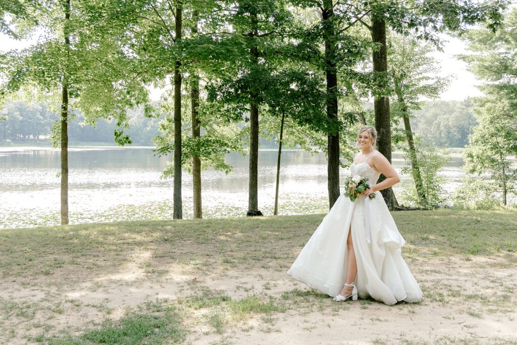 Bride walking along the lakeside at Waltman Lake Lodge