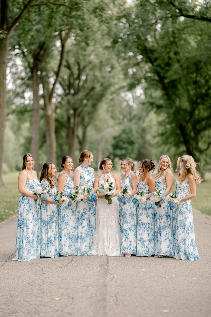 Bridesmaids in blue and white floral dresses with the bride