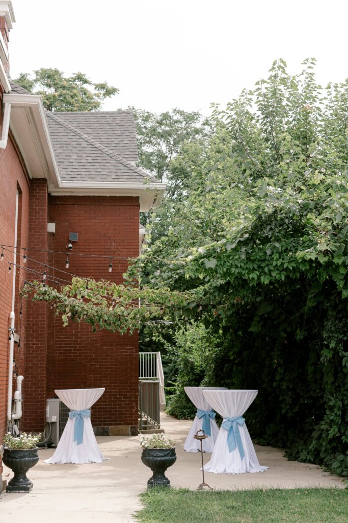 Entrance to The Broadway Avenue wedding venue with cocktail tables outside