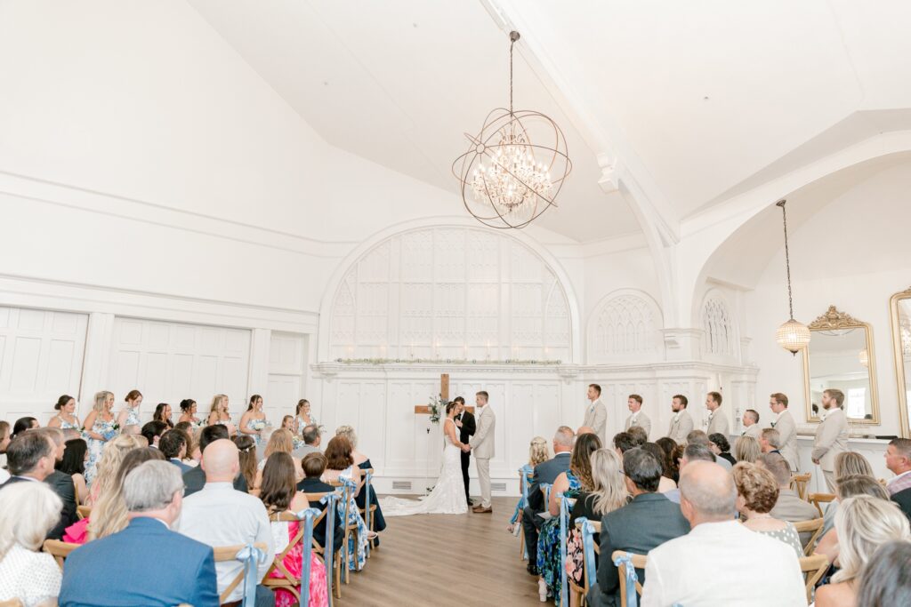 Wedding ceremony inside the bright white chapel at The Broadway Avenue in Grand Rapids