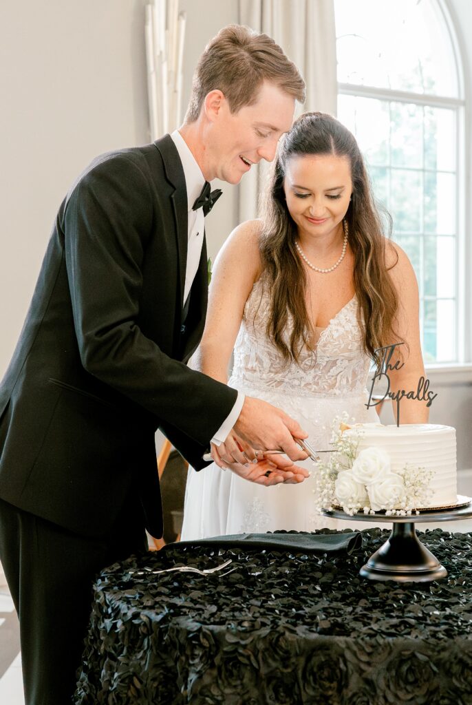 Bride and groom cutting their wedding cake