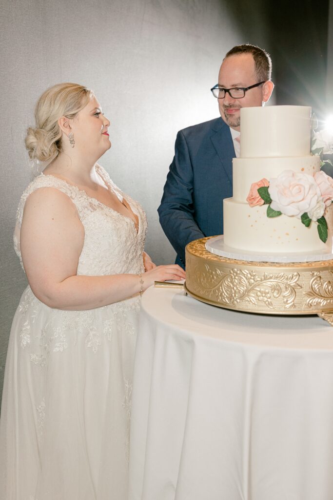 Bride and groom cutting their wedding cake