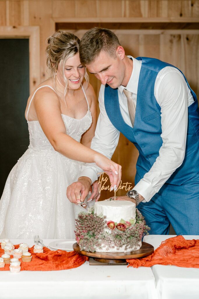 Bride and groom cutting their wedding cake