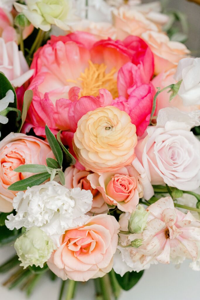 Close-up of a coral peony and blush rose bridal bouquet
