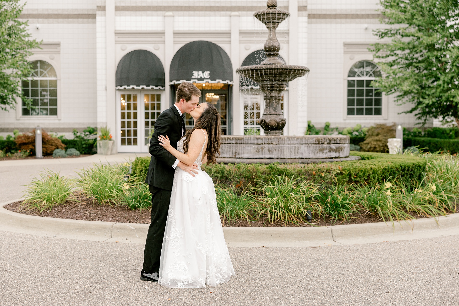 Bride and groom by the courtyard fountain at the Italian American Club of Livonia