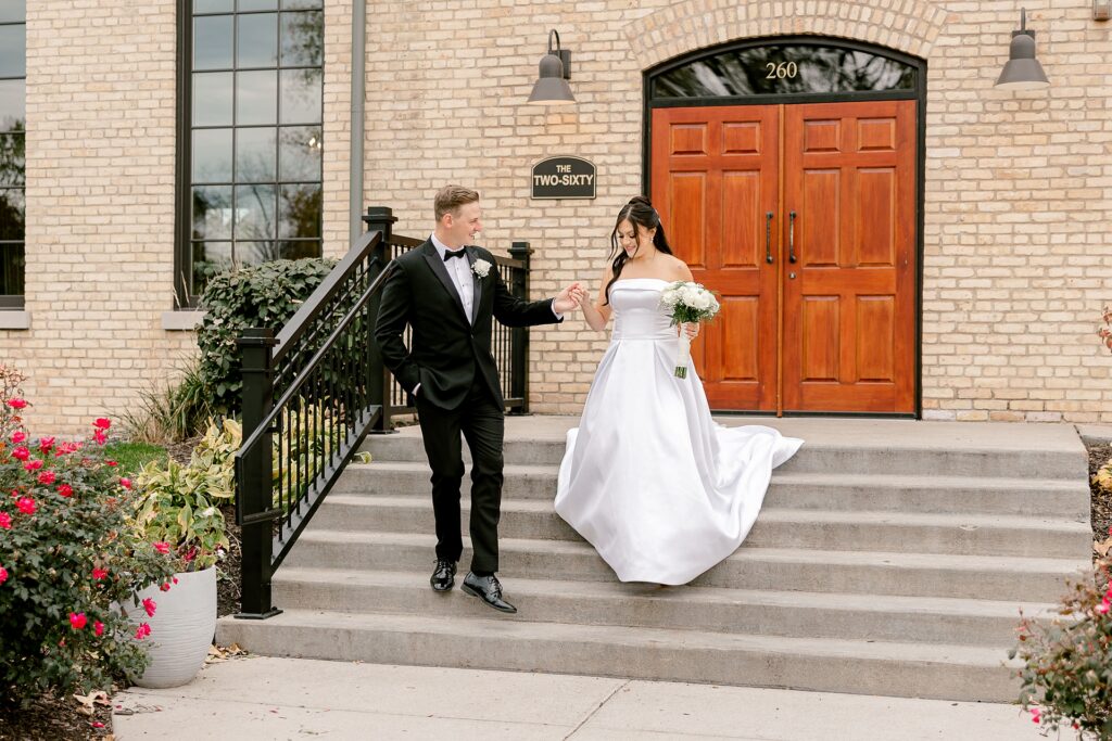 Bride and groom walking down the front steps of The BRIX on Fox
