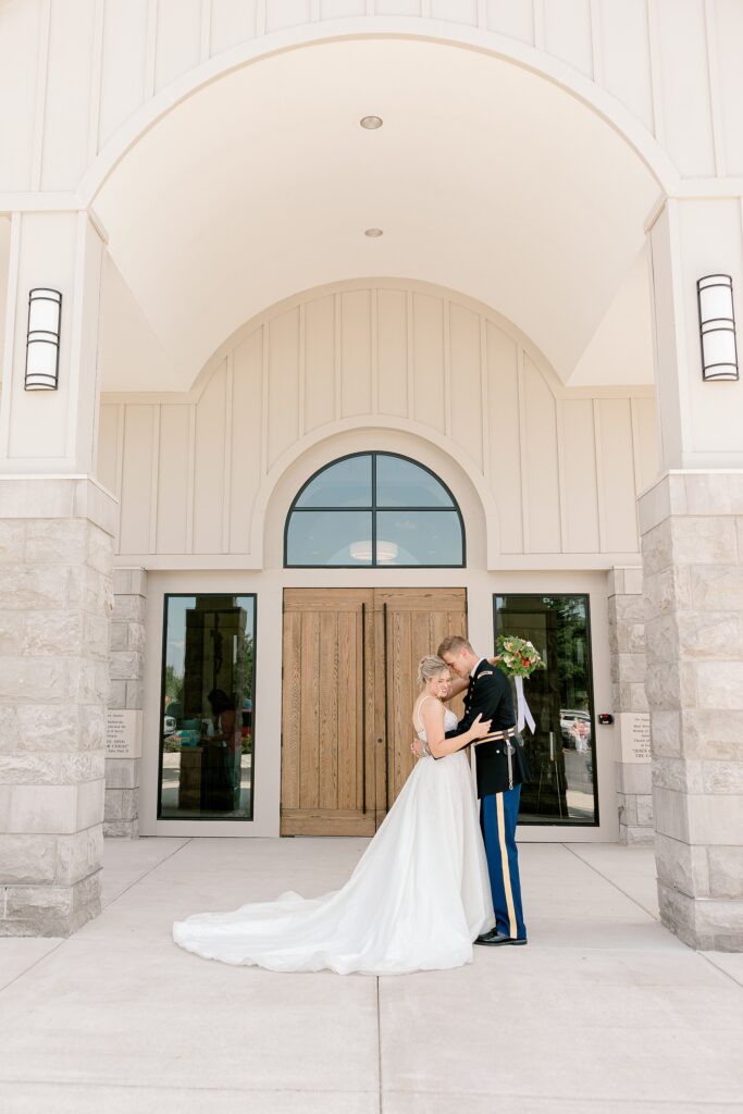 Bride and groom kissing at the church entrance