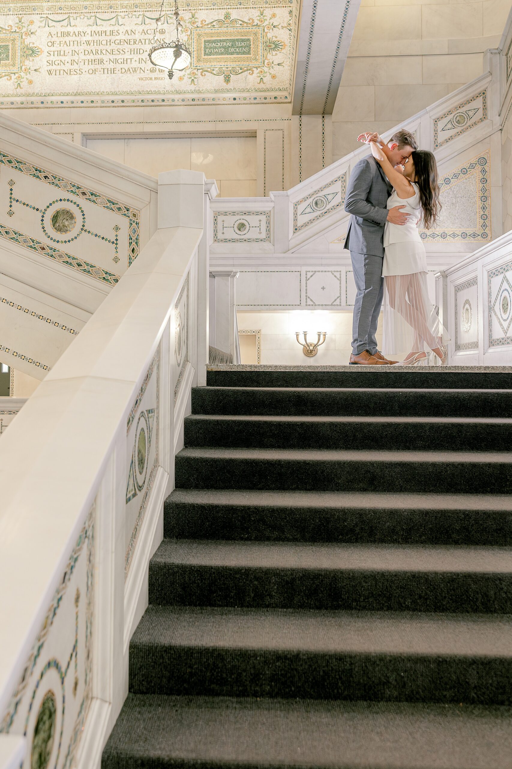 Couple kissing on the marble staircase at the Chicago Cultural Center