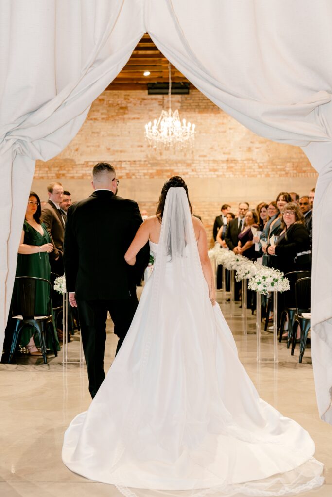 Dad walking the bride down the aisle under draped curtains at The BRIX on Fox
