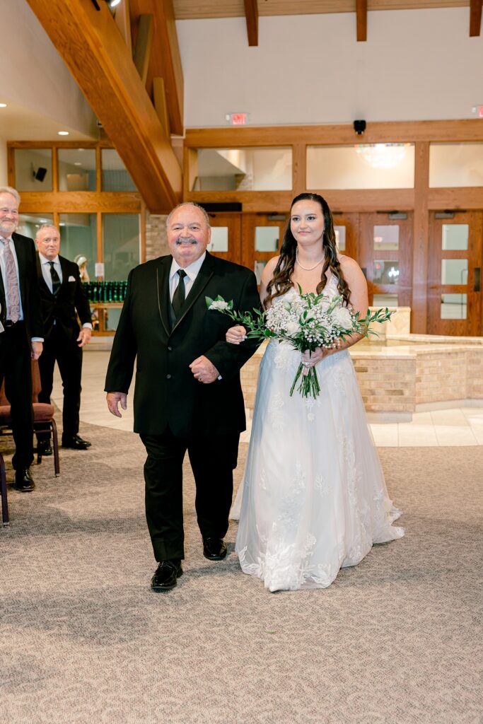 Dad walking the bride down the aisle at St. Thomas A'Becket Catholic Church