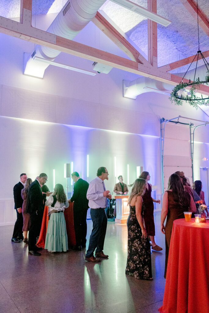 Guests on the dance floor with colorful uplighting at Ivy House