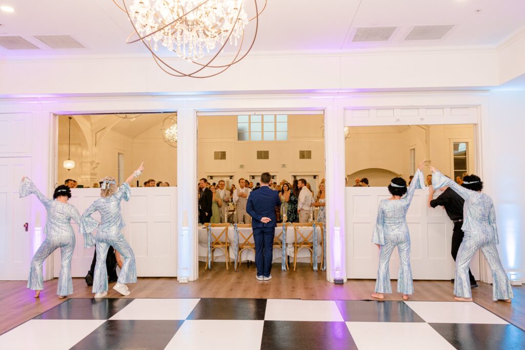 Mom of the bride and her friends performing a Dancing Queen dance on the checkered dance floor at The Broadway Avenue