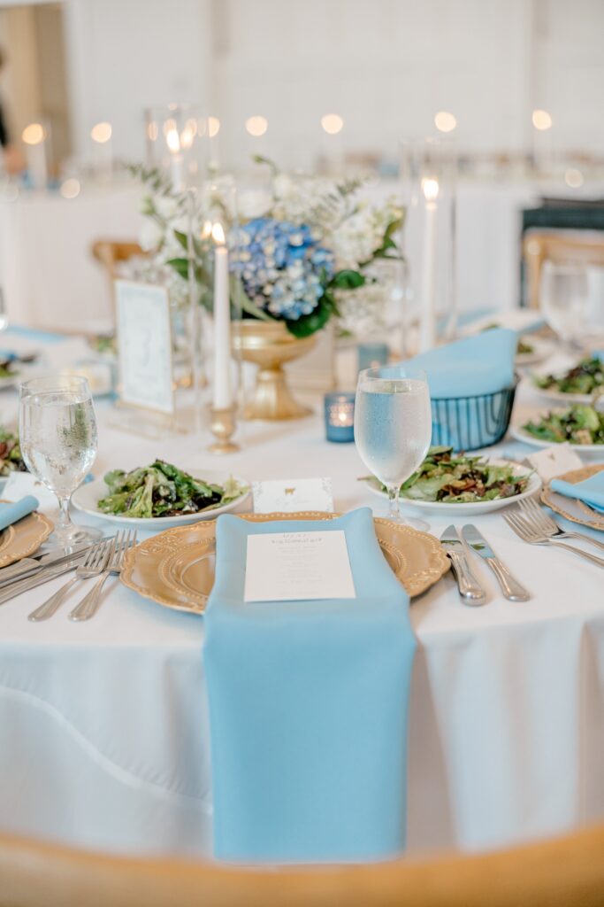 Dusty blue reception table settings with florals