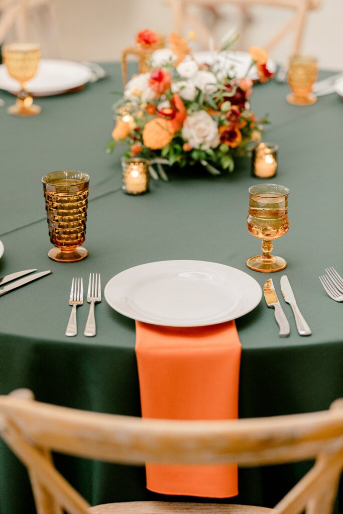 Fall floral centerpiece with amber glassware and candles