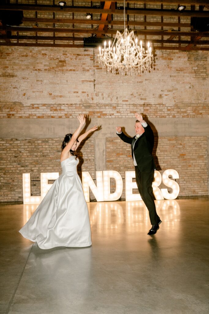 First dance in front of glowing marquee letters at The BRIX on Fox