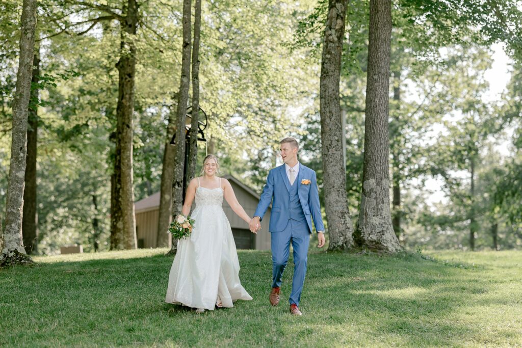 Bride and groom making their grand entrance across the lawn