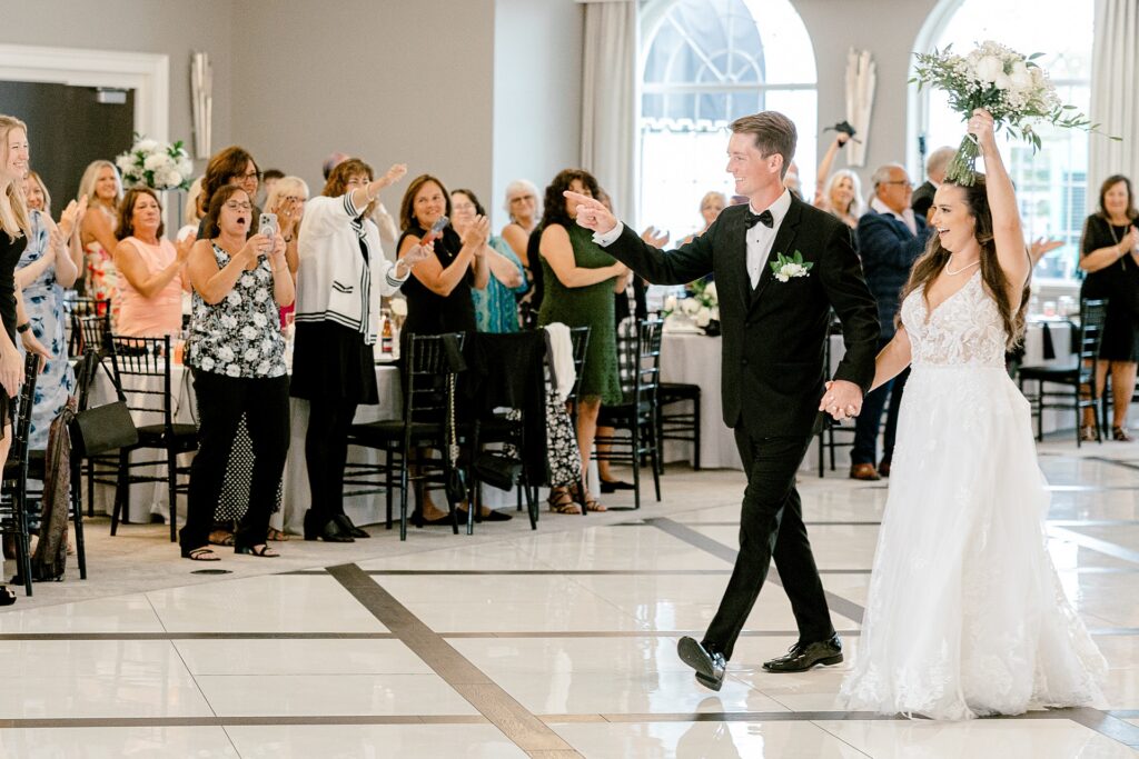 Bride and groom making their grand entrance into the reception