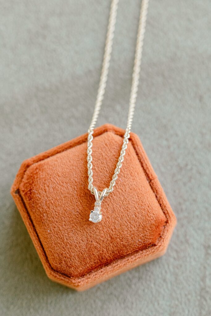 Bride's grandmother's diamond necklace on a rust velvet ring box
