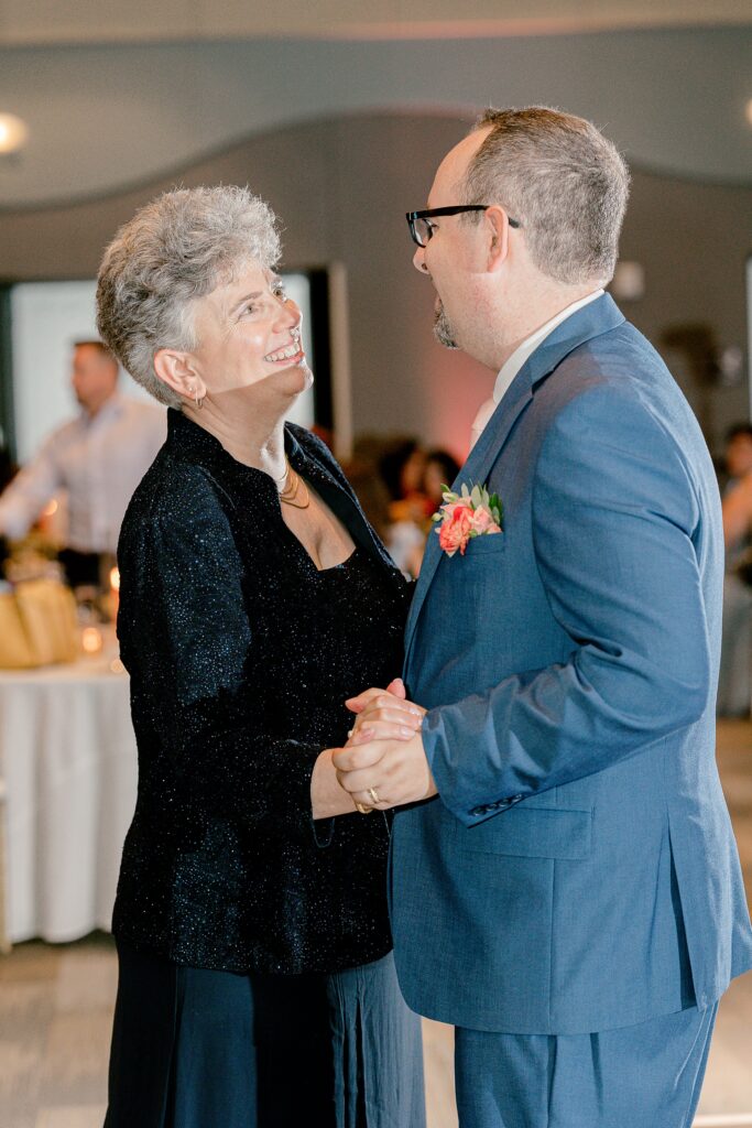 Groom sharing a dance with a loved one at the reception