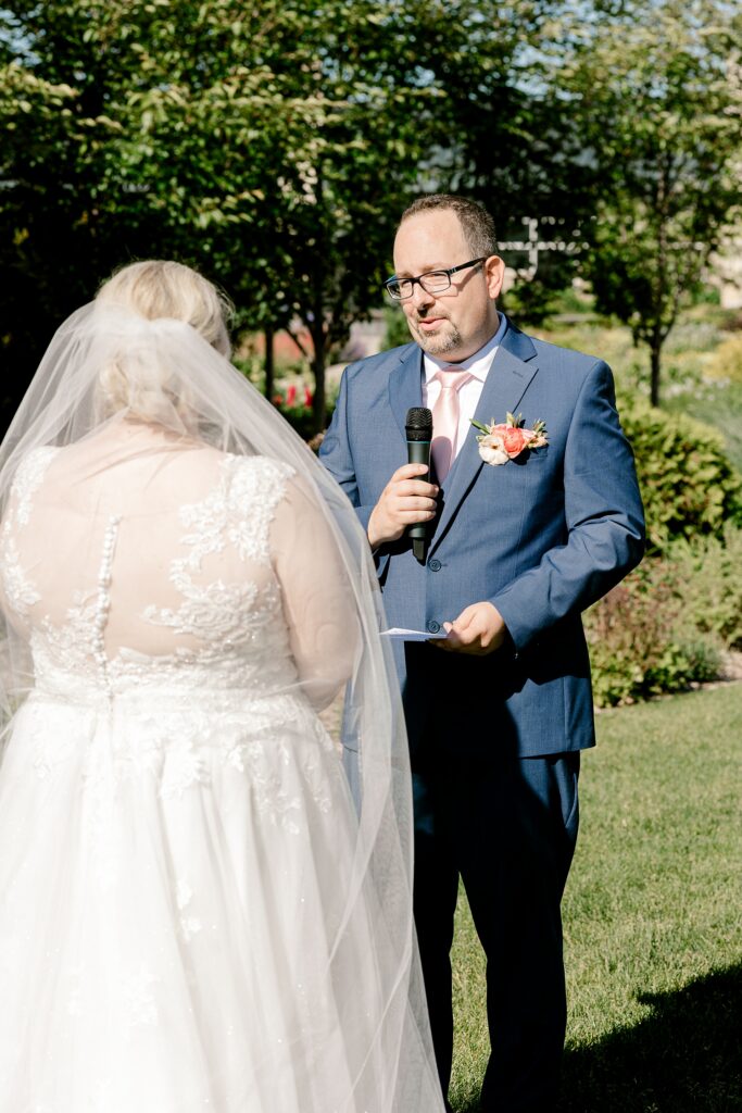 Groom reading his vows to the bride