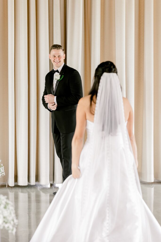 Groom turning around to see his bride during their first look