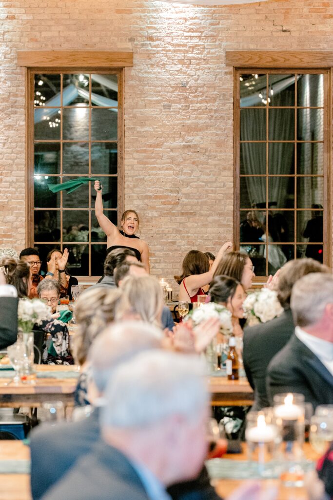 Guests cheering during the wedding reception