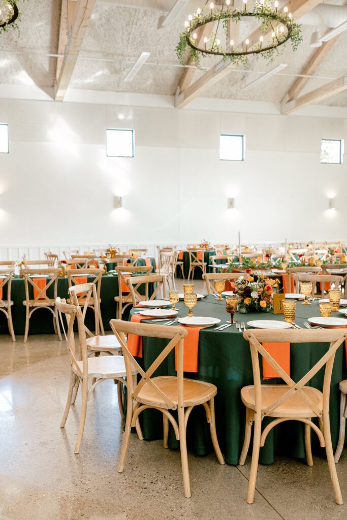 Ivy House reception hall with greenery chandeliers and green linens