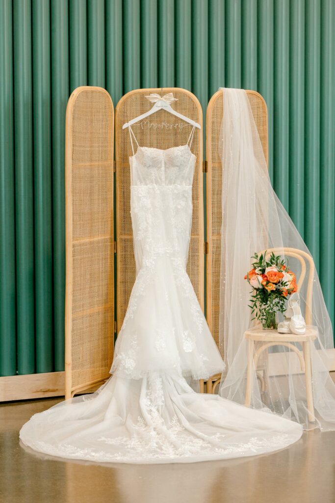 Wedding dress hanging in the green bridal suite at Leona Road in Grand Rapids