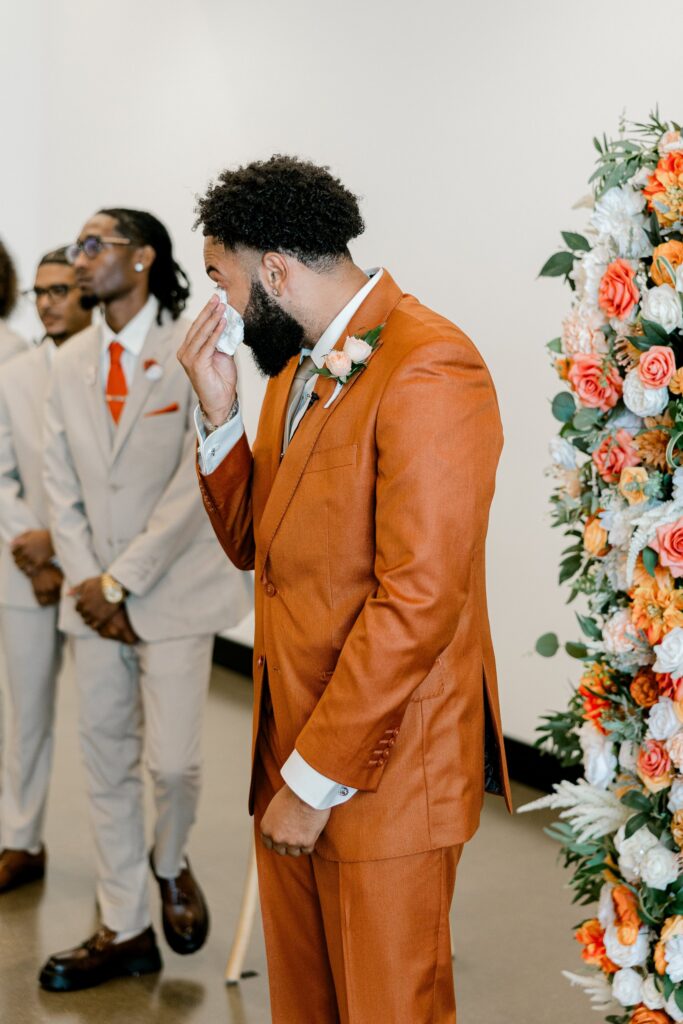 Groom reacting as his bride enters the ceremony at Leona Road