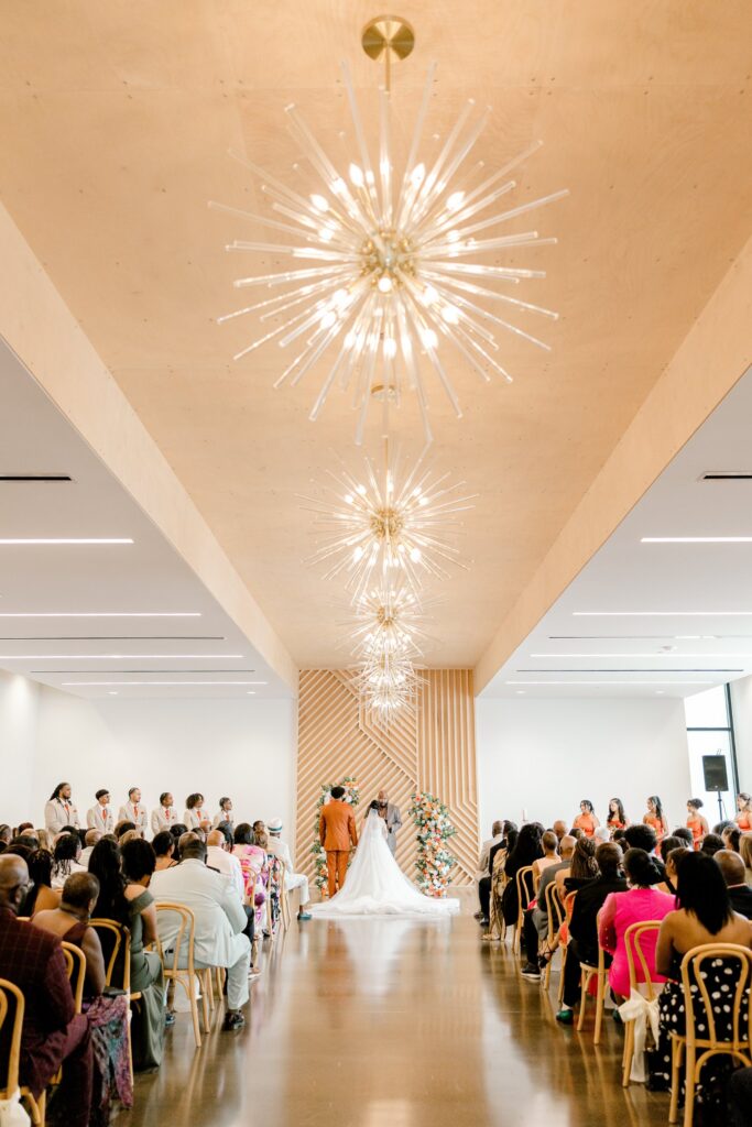 Bride walking down the aisle under the chandeliers at Leona Road in Grand Rapids
