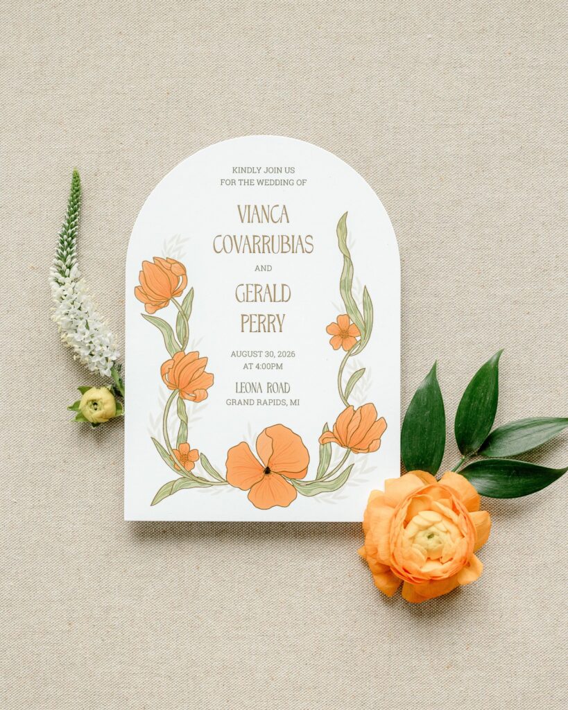 Arched wedding invitation with hand-drawn orange florals for a Leona Road wedding in Grand Rapids