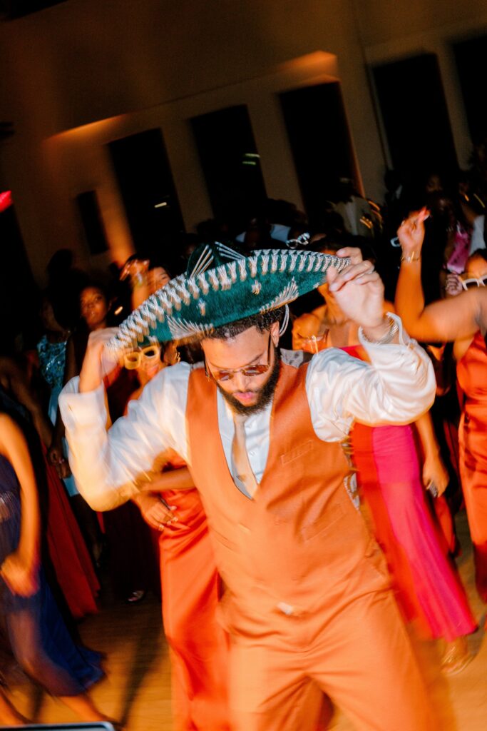 Groom dancing with guests on a packed dance floor at Leona Road