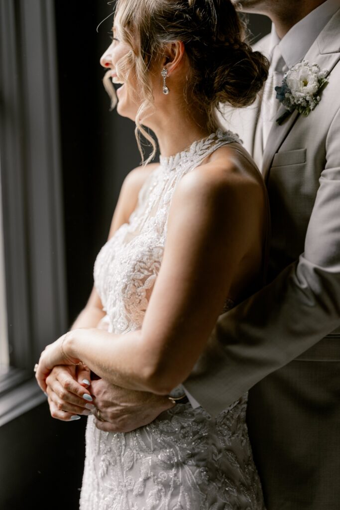 Bride and groom in soft window light during their wedding portraits