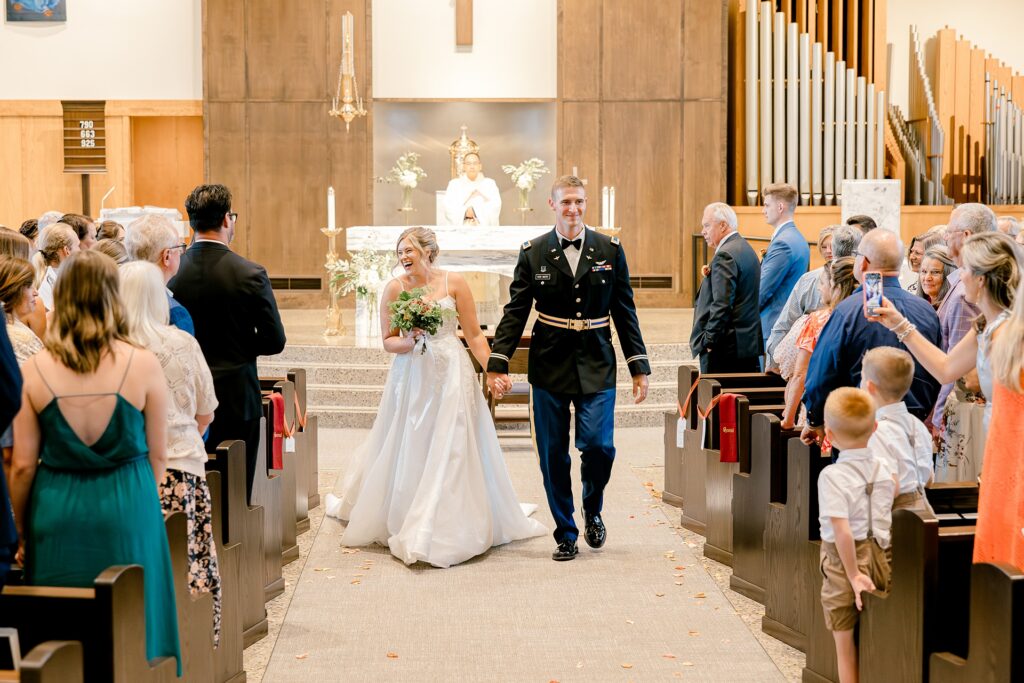 Newlyweds walking back up the aisle after the ceremony
